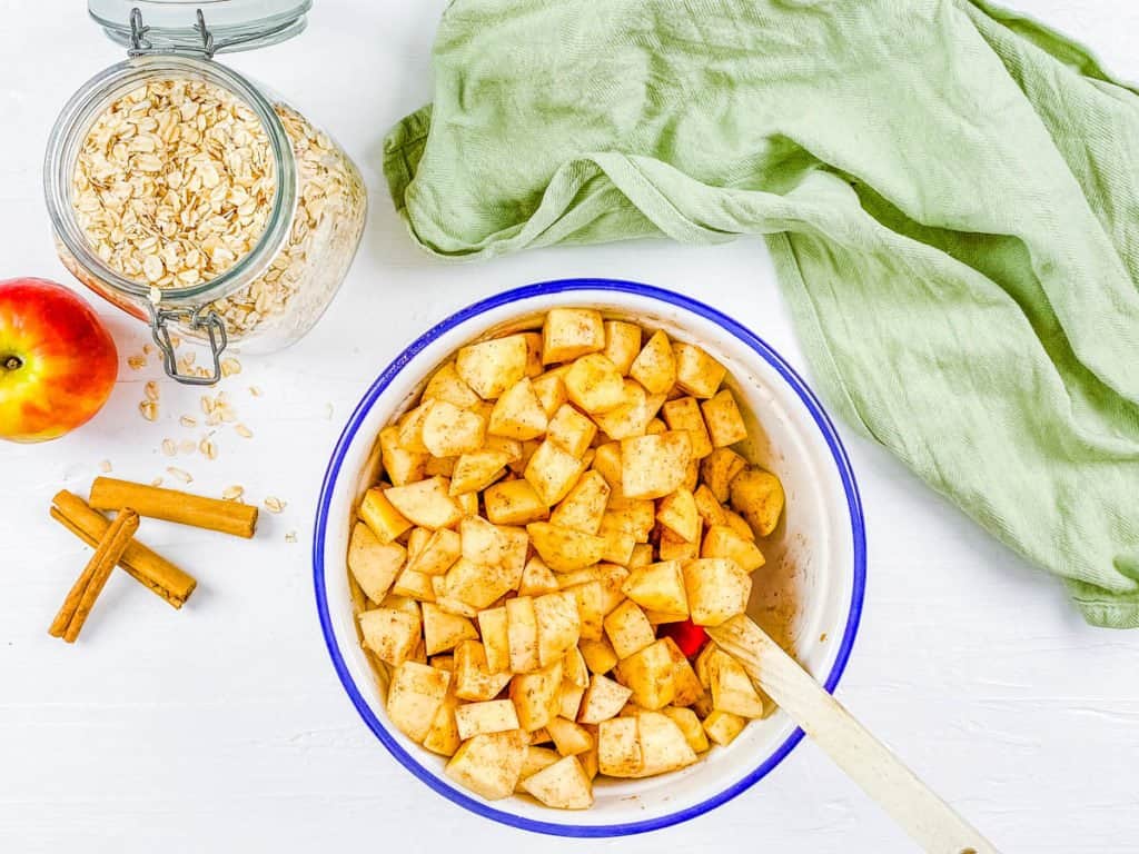 fruit and cinnamon in a mixing bowl