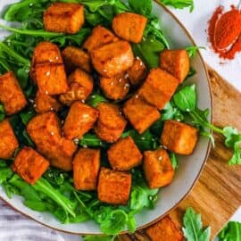 healthy easy vegan air fryer tempeh recipe on a white plate with greens