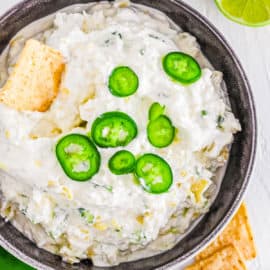 easy vegetarian cold jalapeno artichoke dip recipe in a bowl with chips