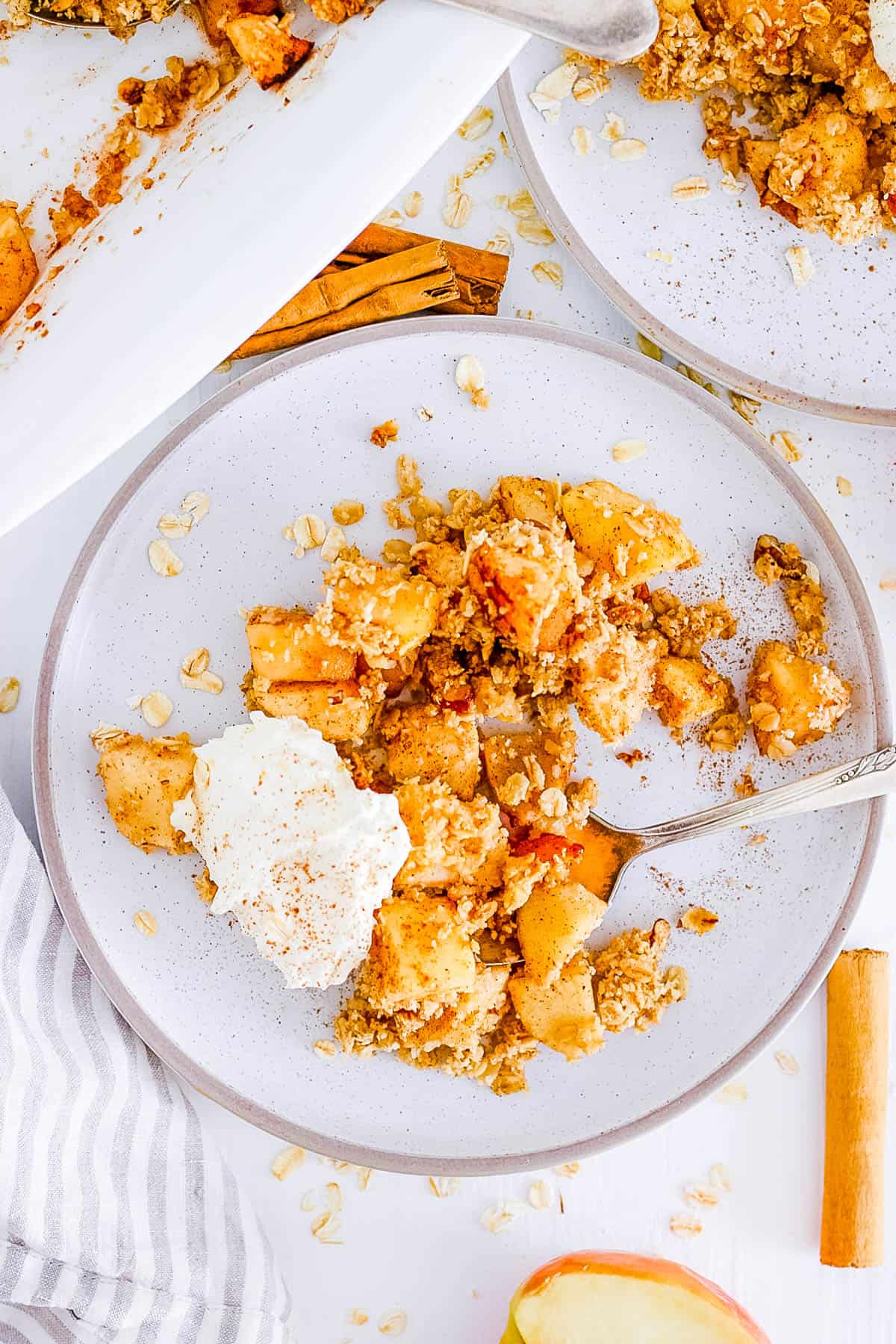 healthy, easy, gluten free, dairy free, vegan apple crumble recipe (apple crisp) on a plate with whipped cream