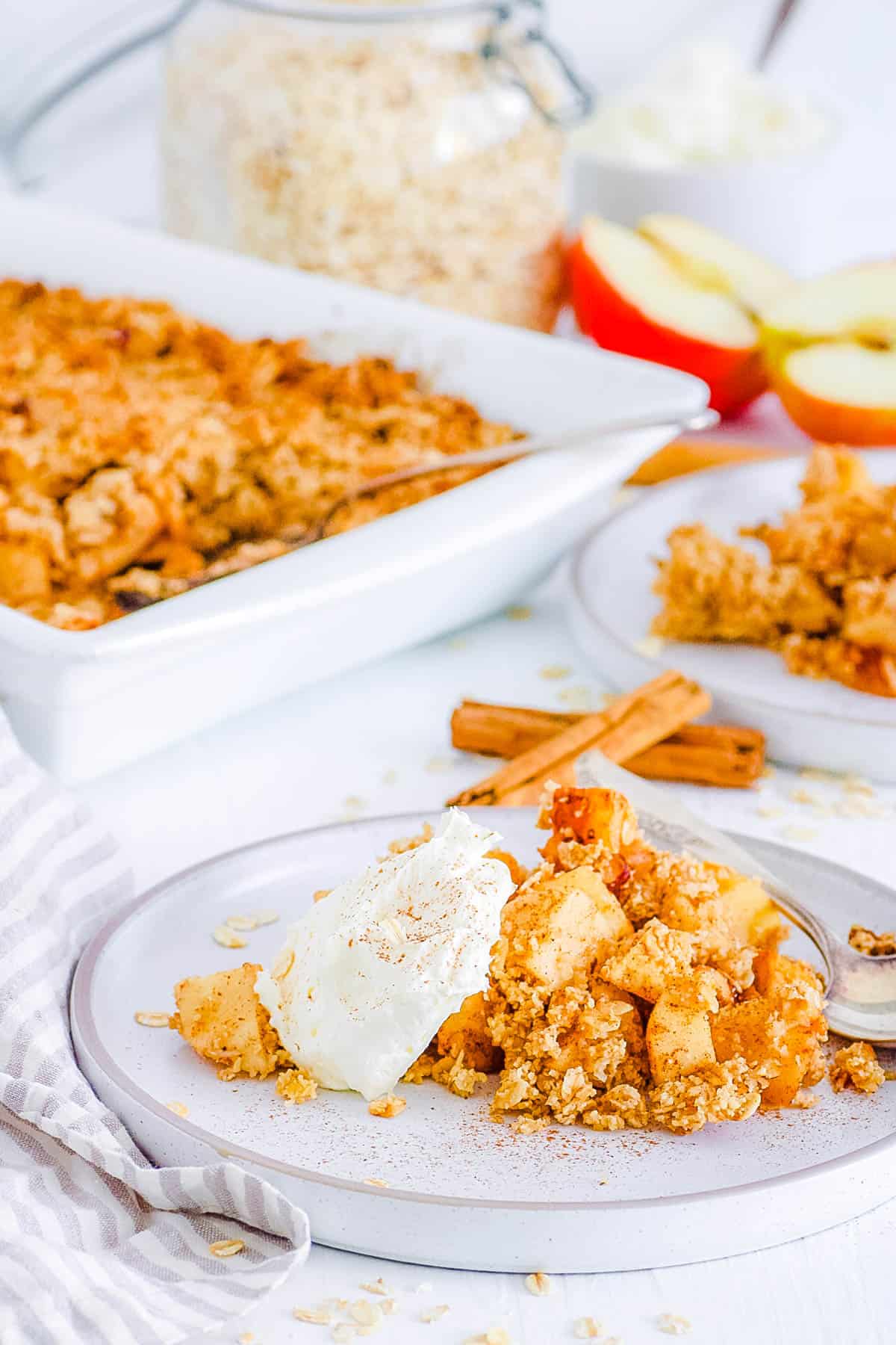 healthy, easy, gluten free, dairy free, vegan apple crumble recipe (apple crisp) on a plate with whipped cream