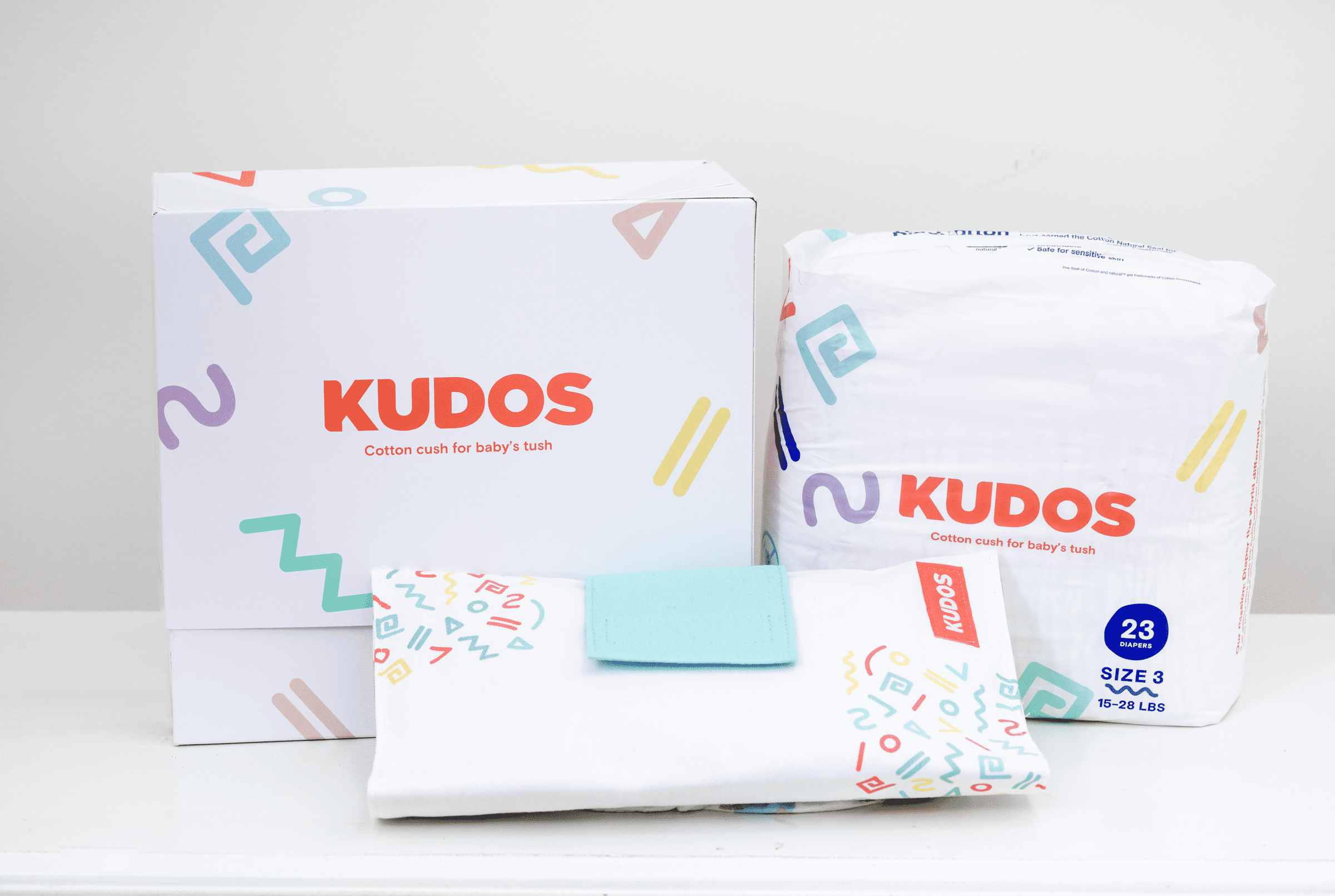 kudos diaper review - packages of kudos diapers against a white background