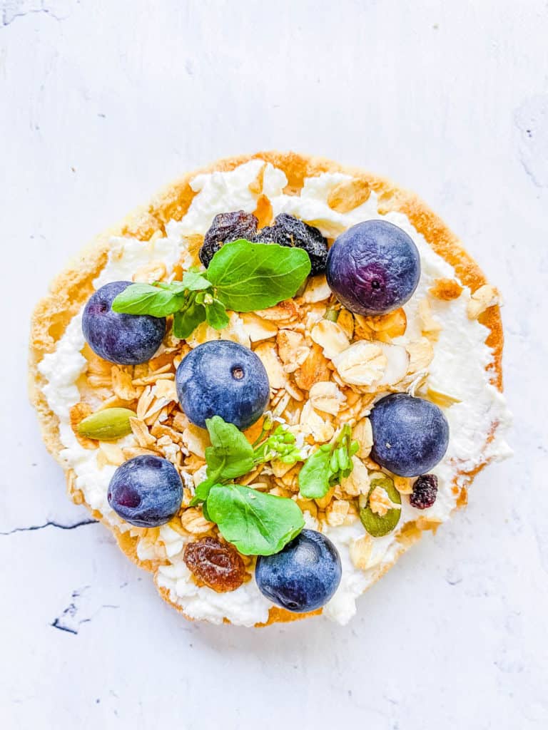 ricotta granola and berries on an english muffin