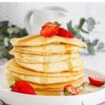 a stack of pancakes with strawberries