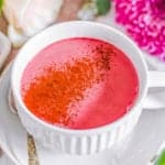 easy healthy vegan beet root pink latte recipe in a white mug with cinnamon on top