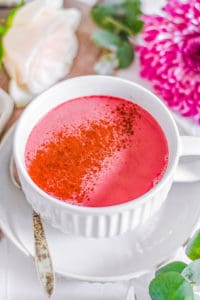 easy healthy vegan beet root pink latte recipe in a white mug with cinnamon on top