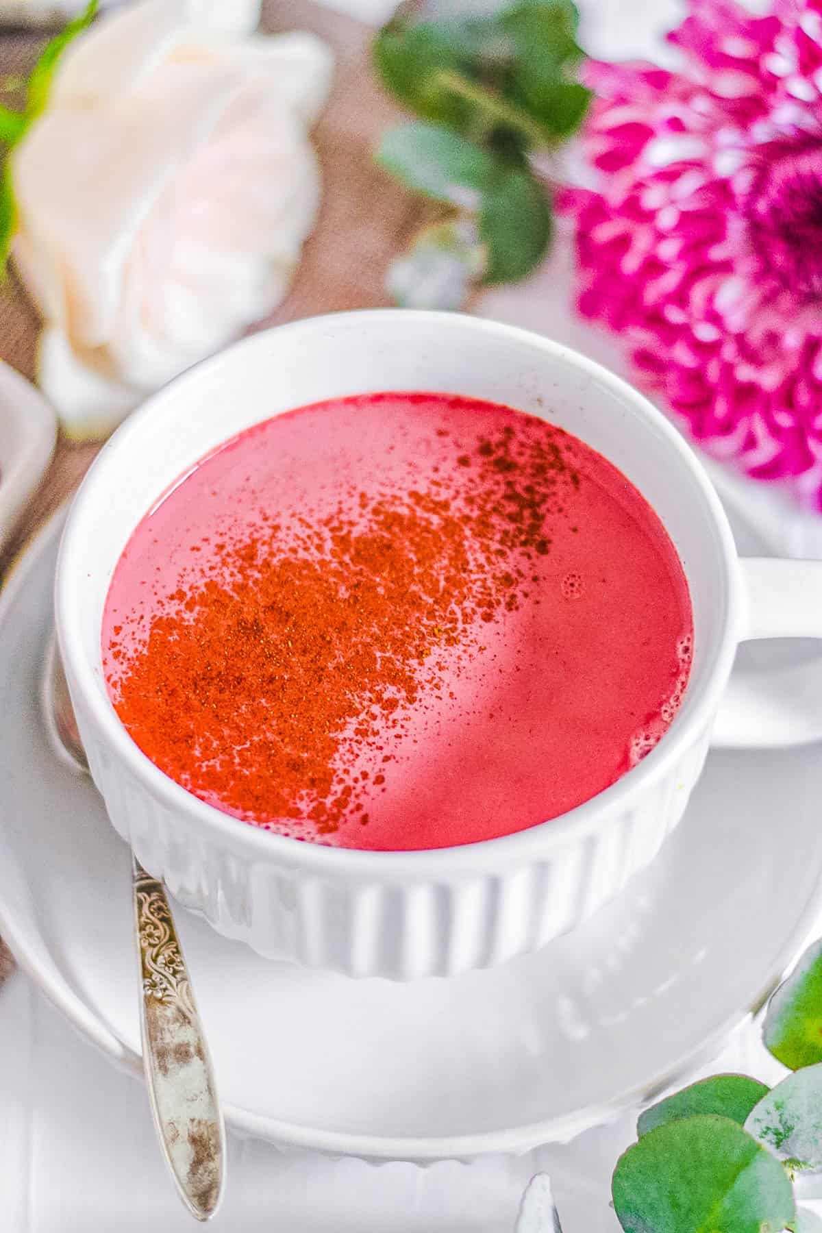 easy healthy vegan beet root pink latte recipe in a white mug with cinnamon on top