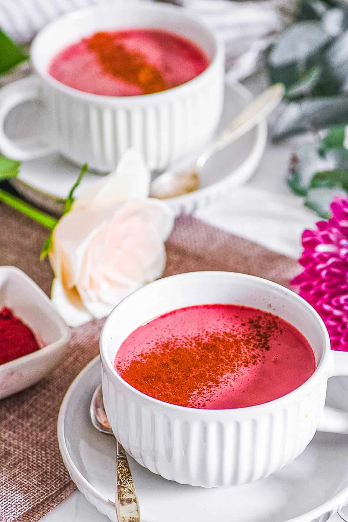 easy healthy vegan beet root pink latte recipe in a white mug with cinnamon on top