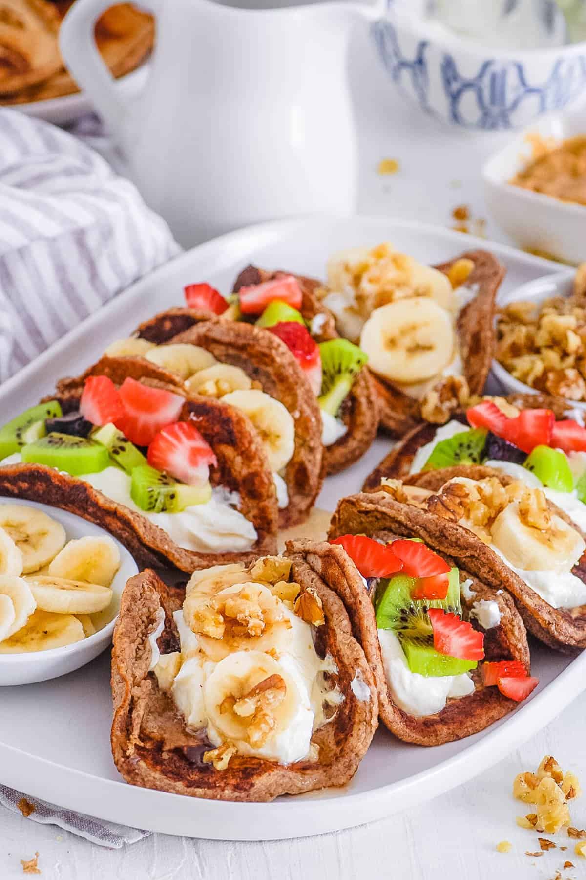 easy healthy vegan protein pancake tacos with fruit filling on a serving platter