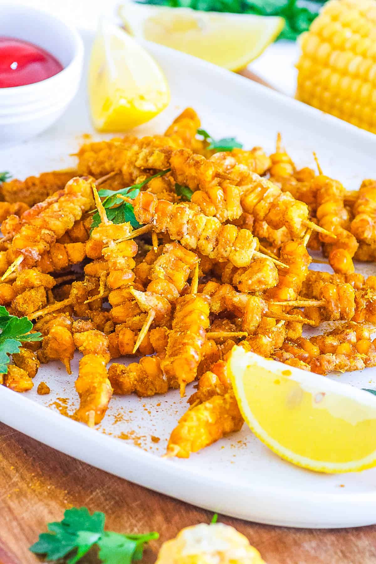 easy vegan gluten free healthy loaded corn fries recipe - masala corn fries on a white plate.