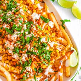 easy vegan gluten free healthy loaded corn fries recipe - mexican street corn fries on a white plate.