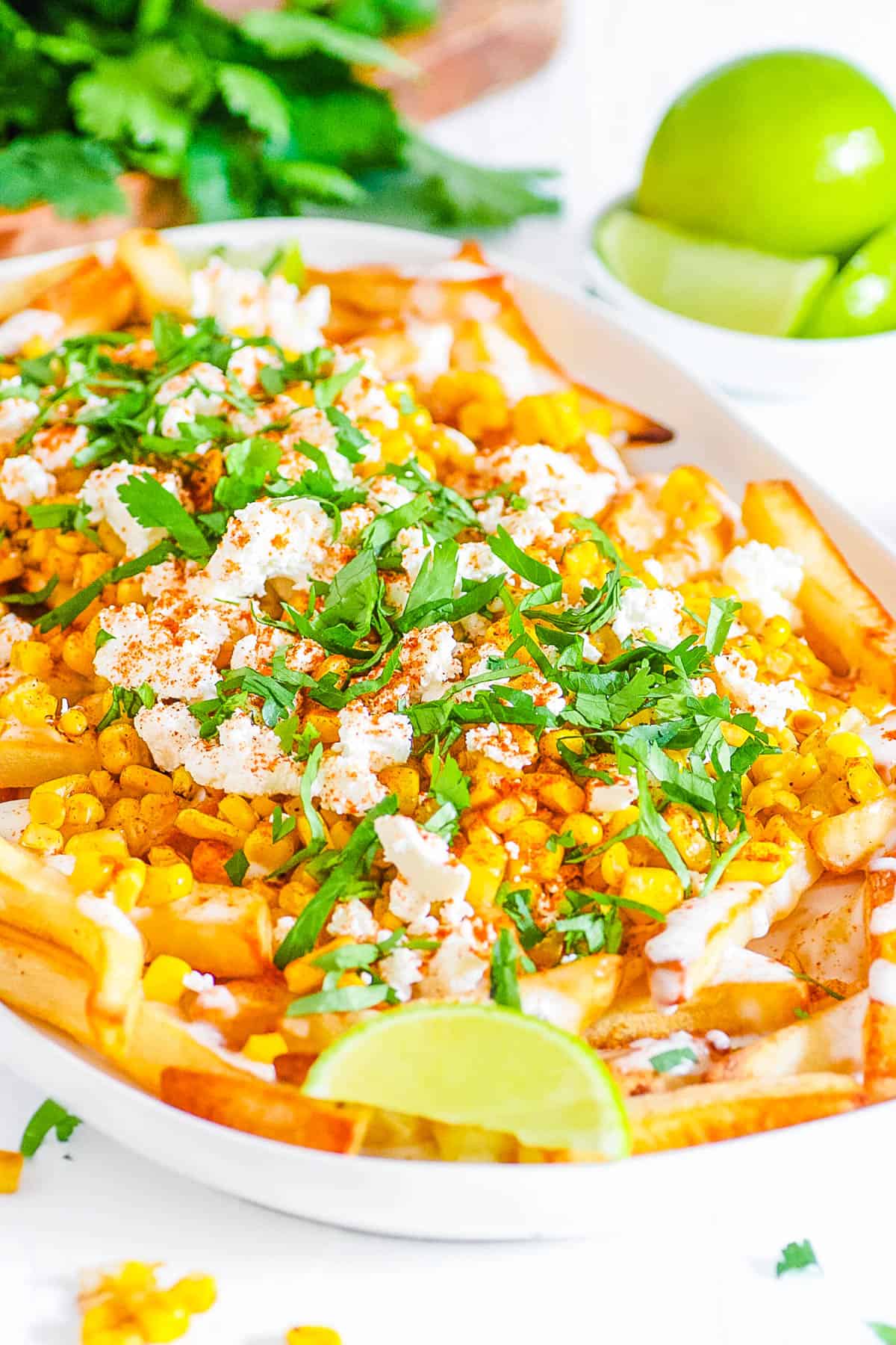 easy vegan gluten free healthy loaded corn fries recipe - mexican corn fries on a white plate.