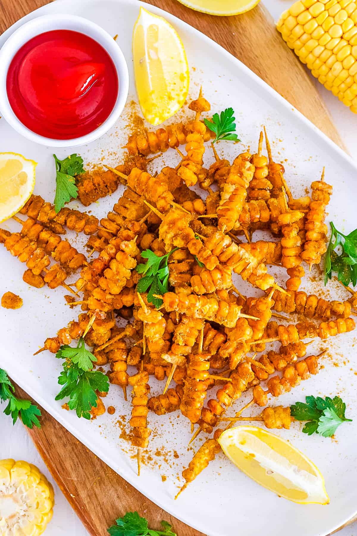 easy vegan gluten free healthy loaded corn fries recipe - masala corn fries on a white plate.
