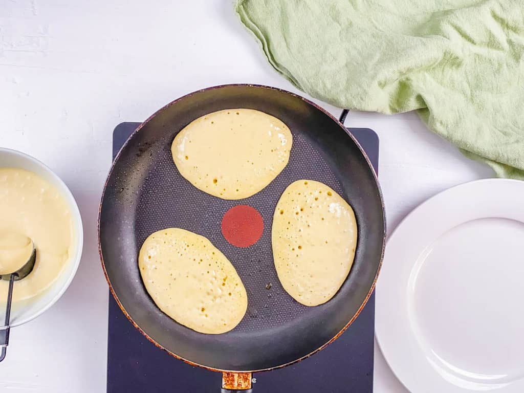 Almond milk pancake batter poured onto a skillet. 