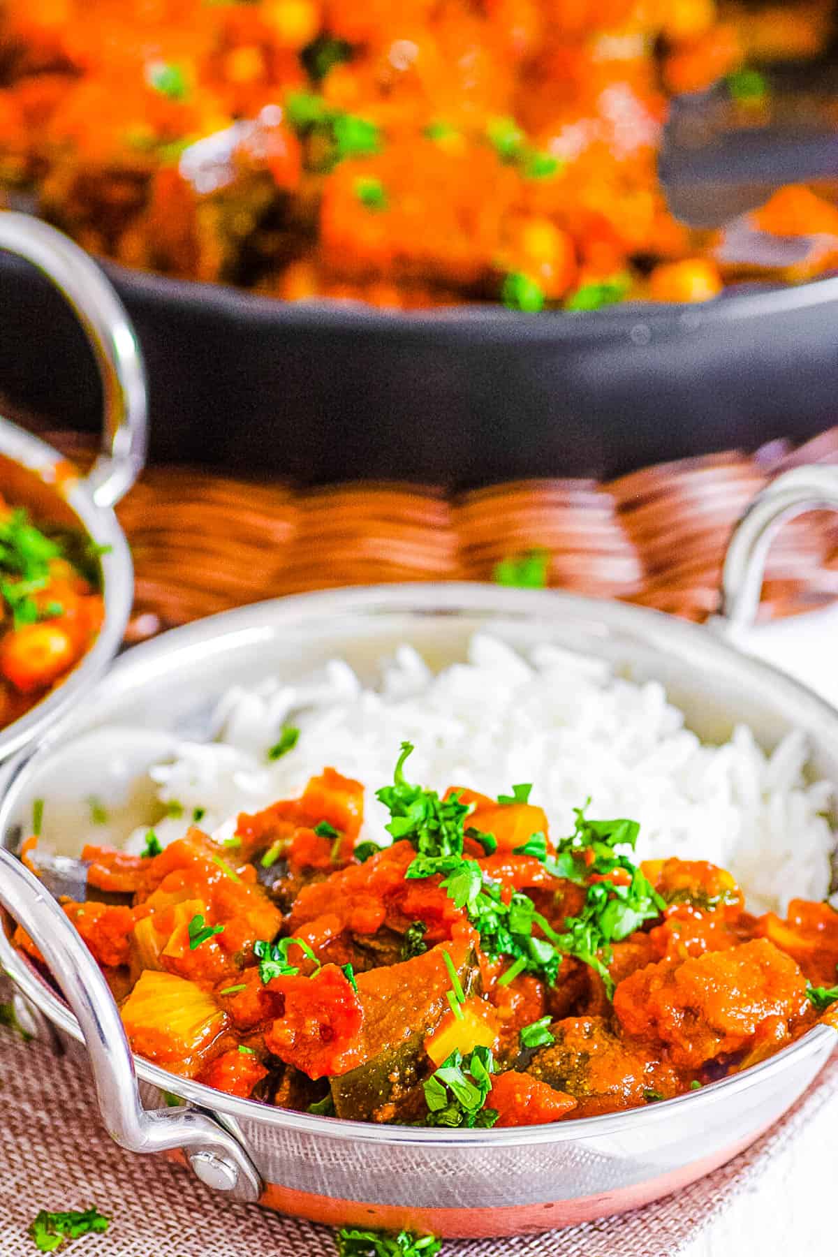 aubergine curry (or brinjal curry / eggplant curry) served with rice in a bowl