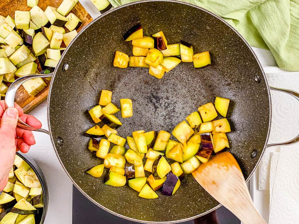 eggplant sauteeing in a pan