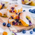 baked blueberry donuts on a wooden cutting board