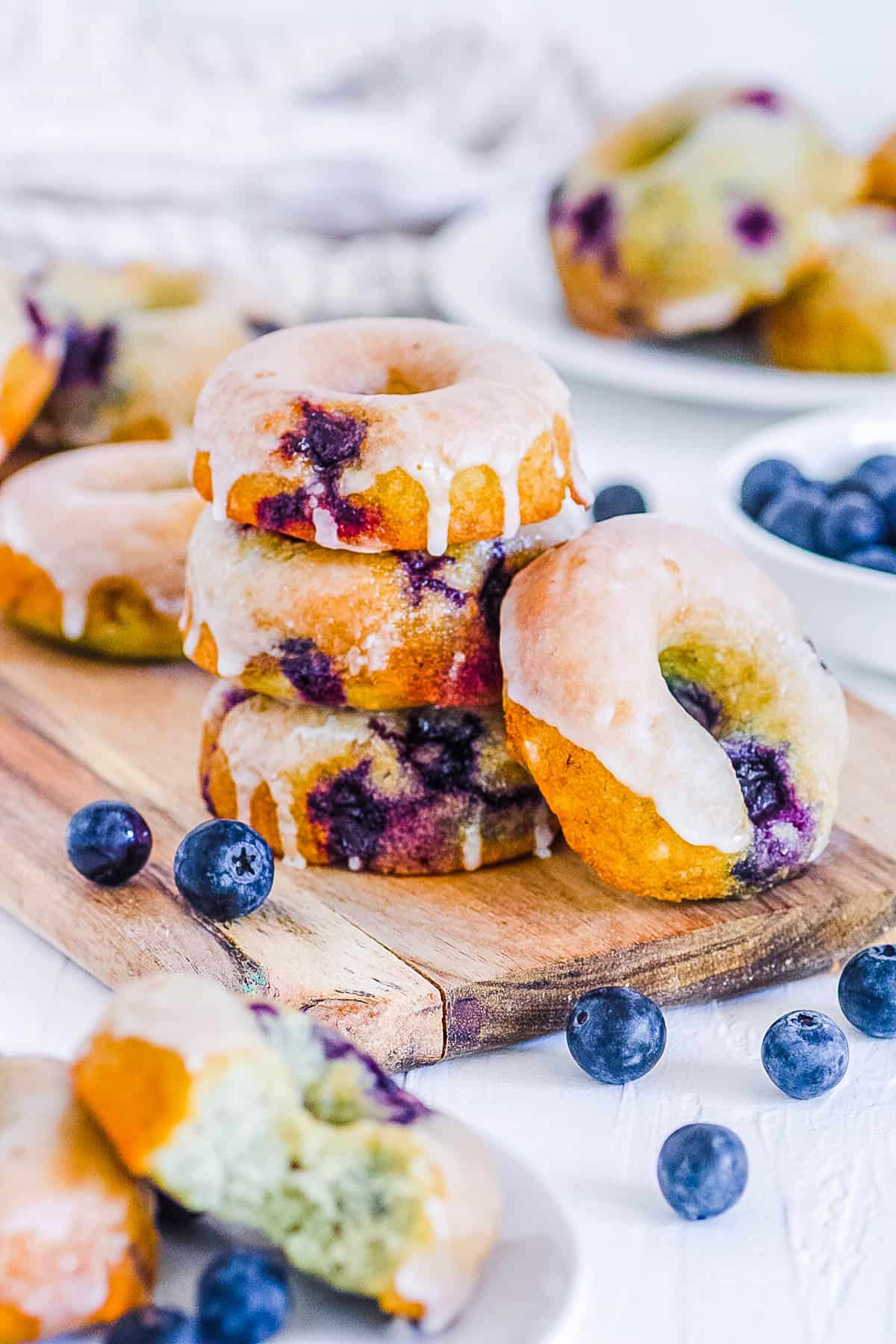 baked blueberry donuts on a wooden cutting board