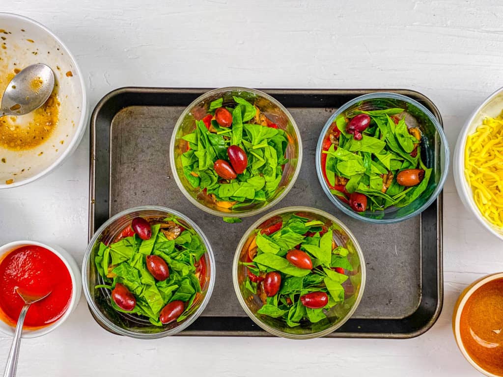 veggies in ramekins on a baking sheet