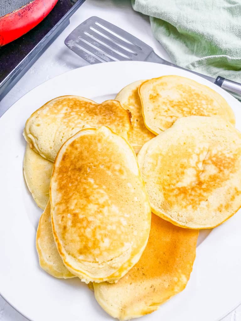 A pile of almond milk pancakes on a plate.