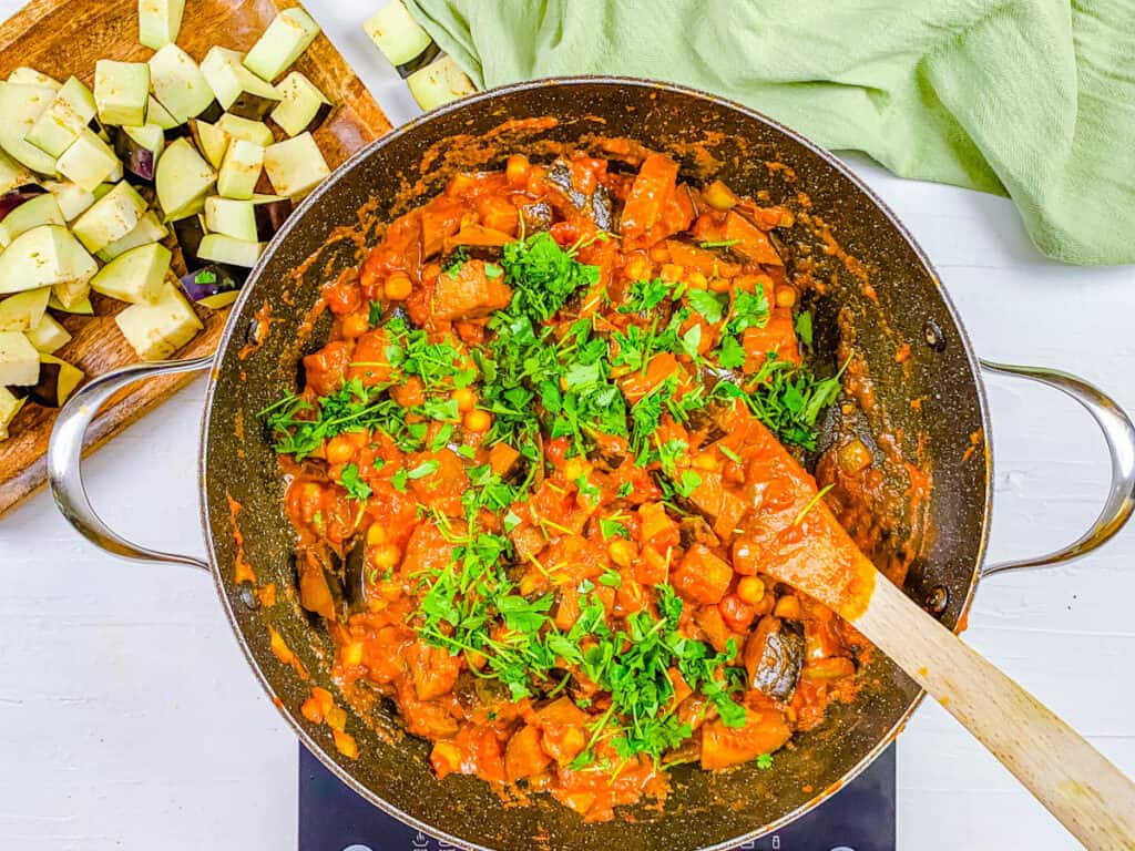 cilantro added to chickpea and eggplant curry