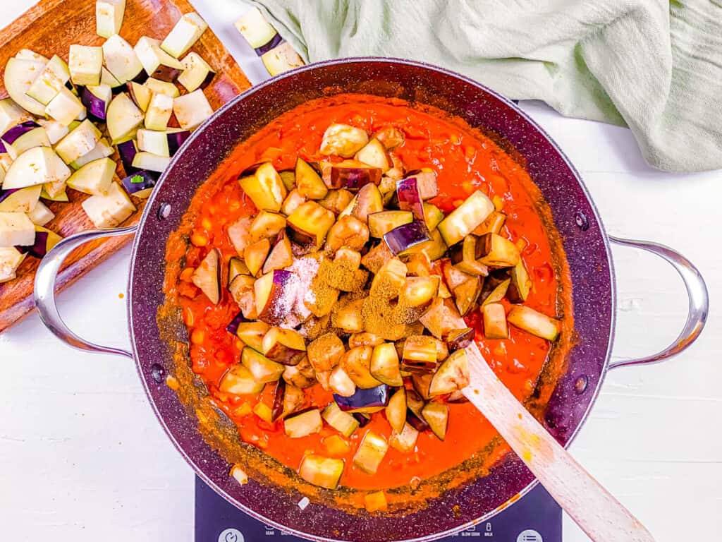 eggplant and tomatoes added to pot