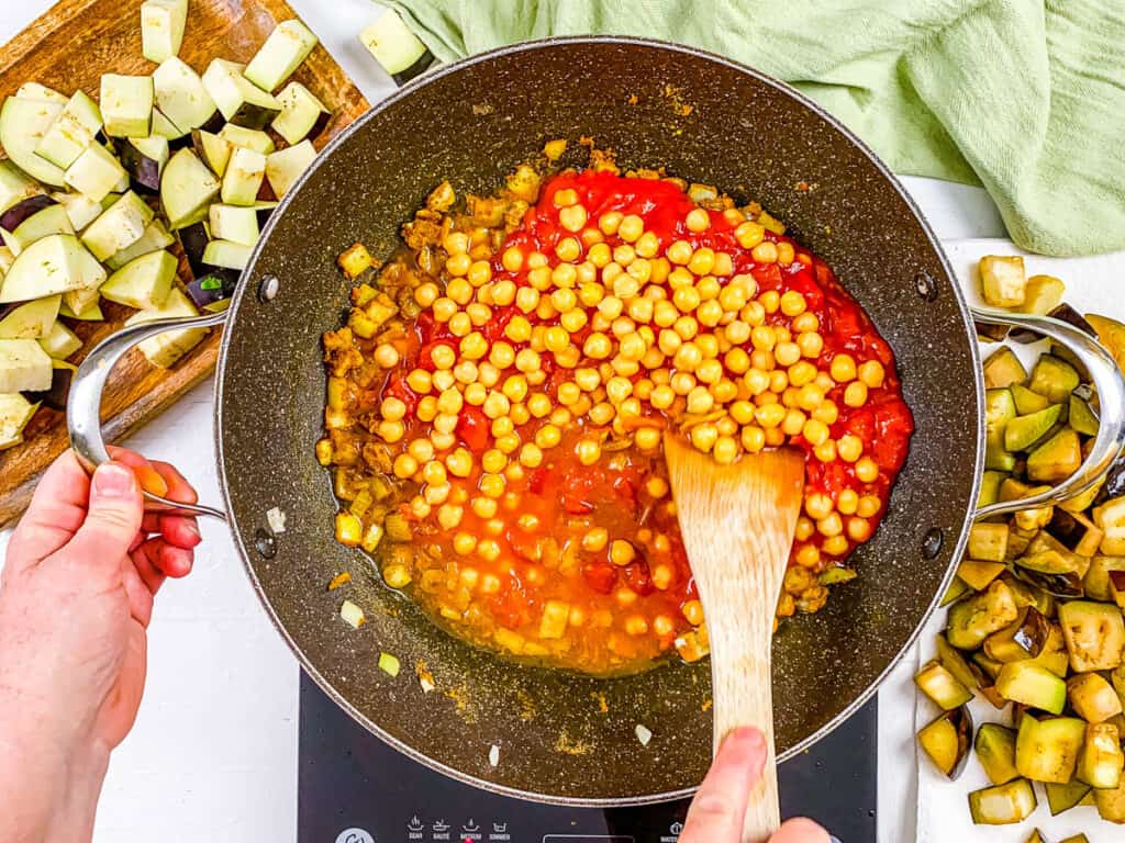 chickpeas added to pot with eggplant curry