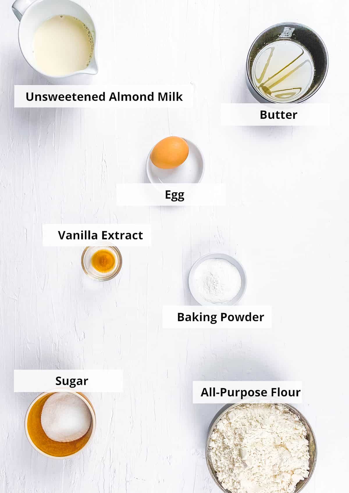All of ingredients for almond milk pancakes recipe on a white background.