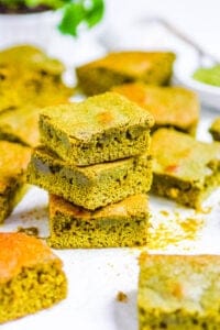 best matcha brownies stacked on white parchment