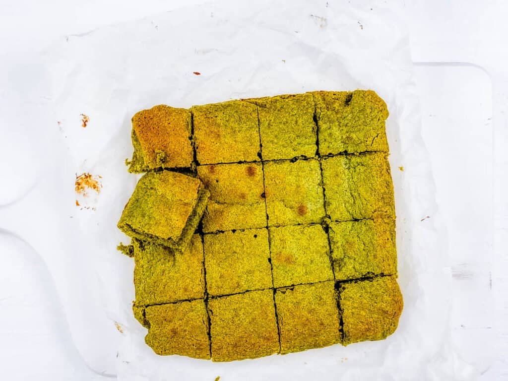 white chocolate matcha brownies cut on parchment