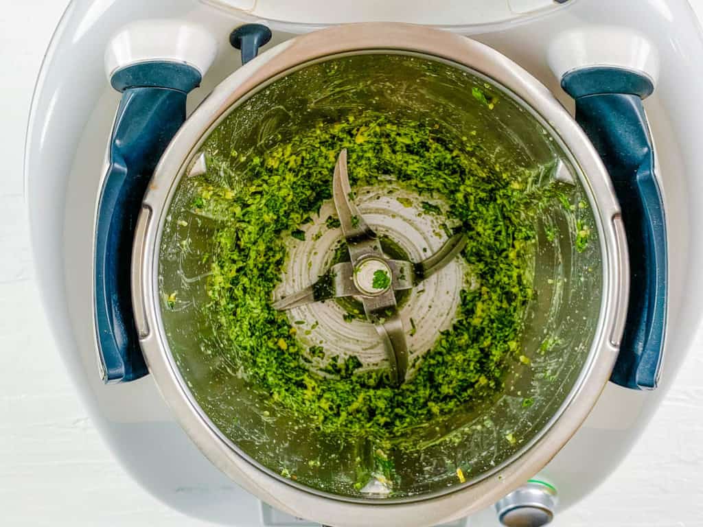 herbs and walnuts blended together in a food processor