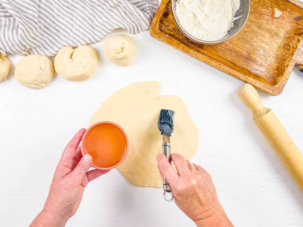 paratha dough on a cutting board rolled out