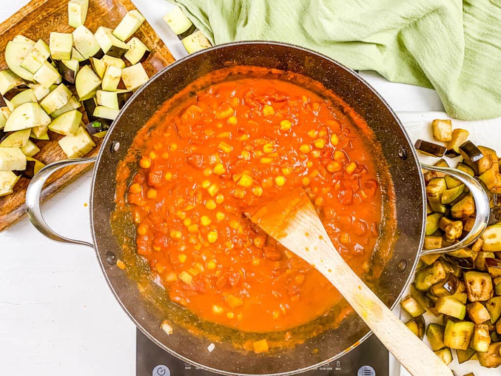 tomatoes and chickpeas added to pot