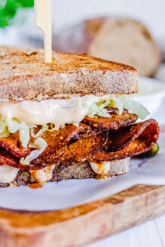 vegan pastrami sandwich on a cutting board