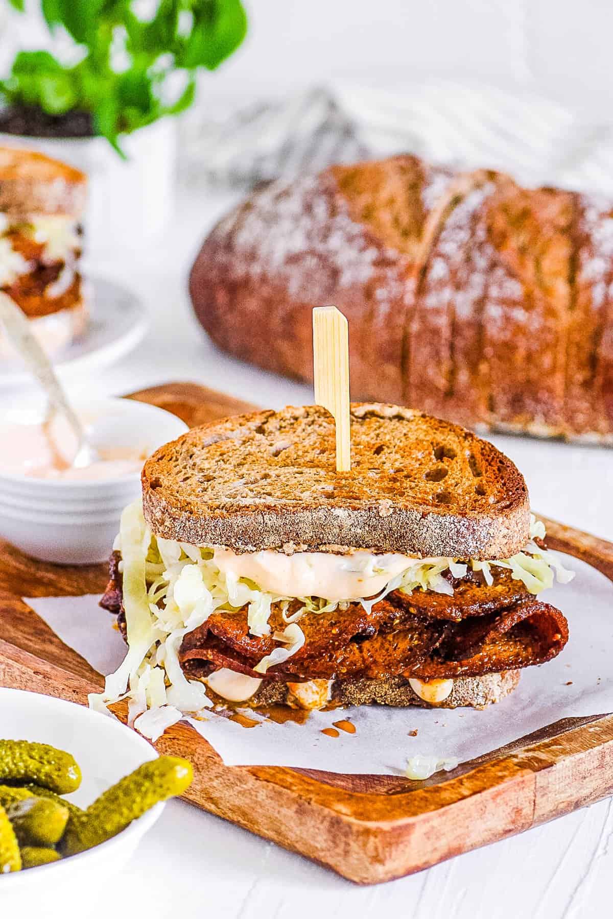 vegan pastrami sandwich on a cutting board