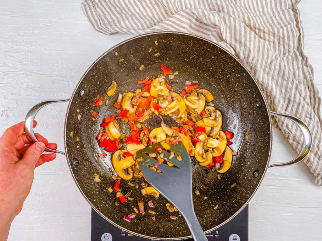 veggies sauteeing in a pan