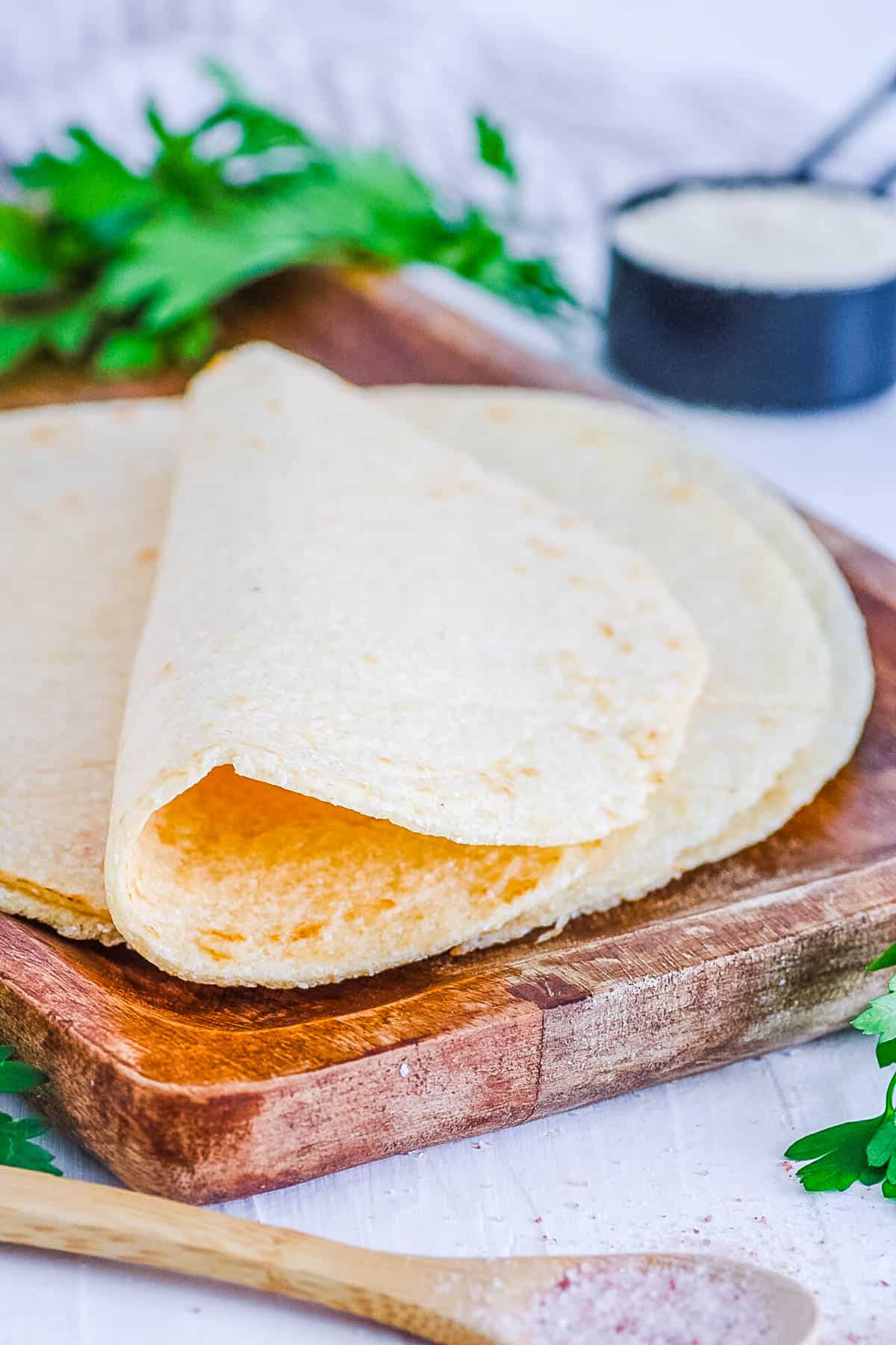 Low carb almond flour tortillas on a wooden cutting board.