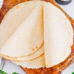 Healthy almond flour tortillas on a wooden cutting board.