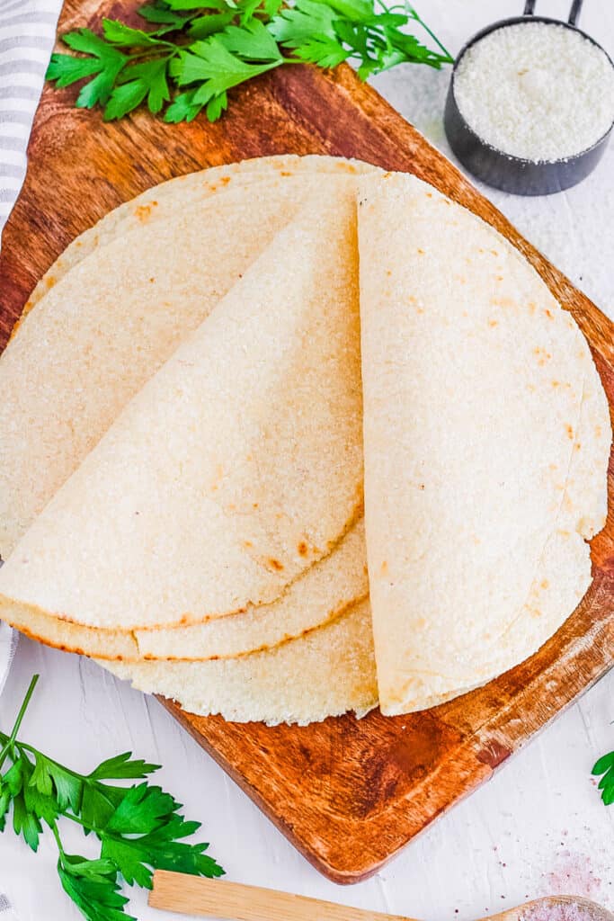 Healthy almond flour tortillas on a wooden cutting board.
