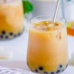 Easy wintermelon milk tea with boba pearls in a gl، with a straw.