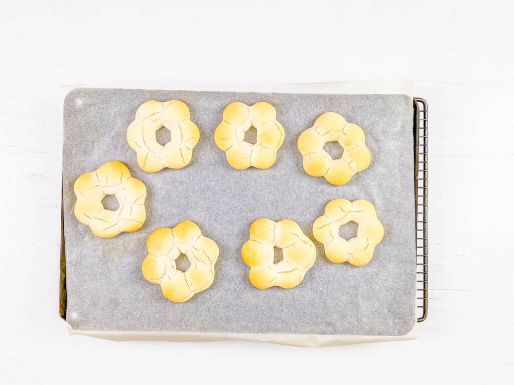 Baked mochi donuts on a sheet pan.