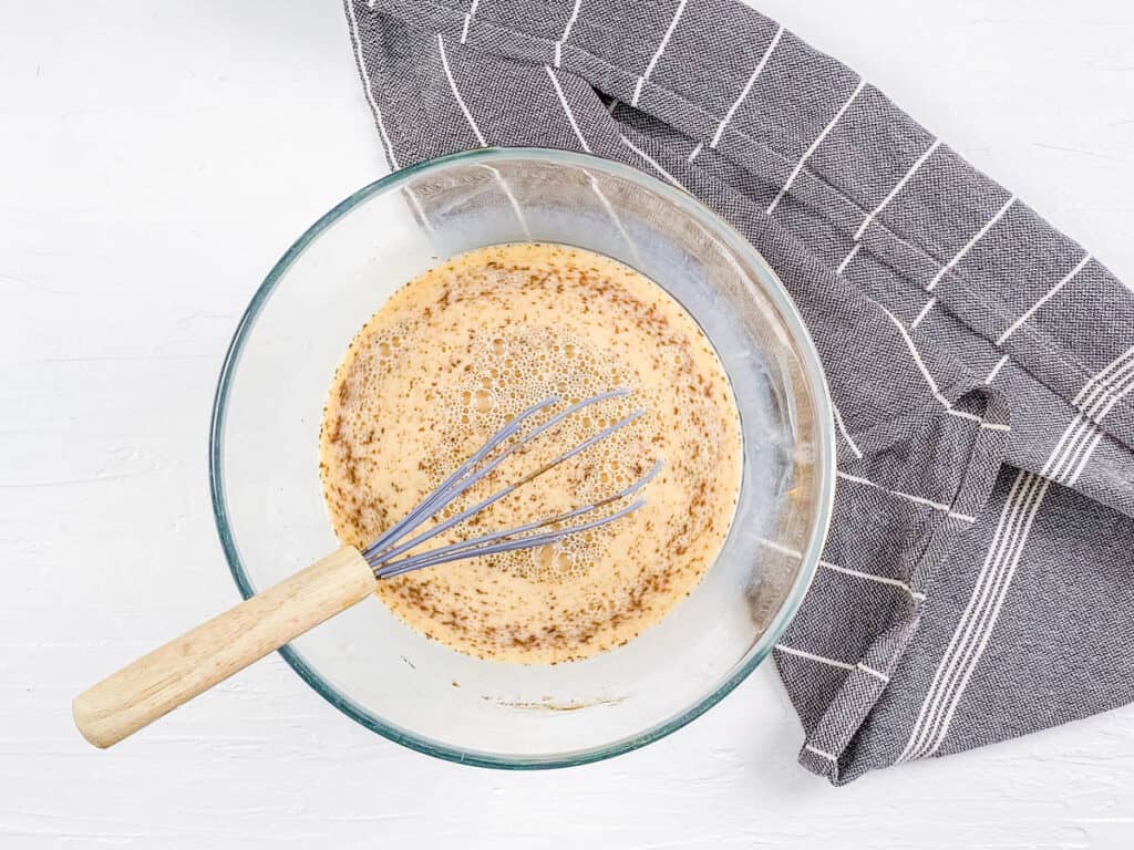 Slow cooker french toast egg custard in a mixing bowl.