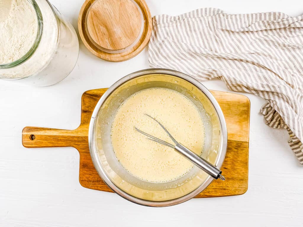 Batter for sourdough discard pancakes in a mixing bowl.