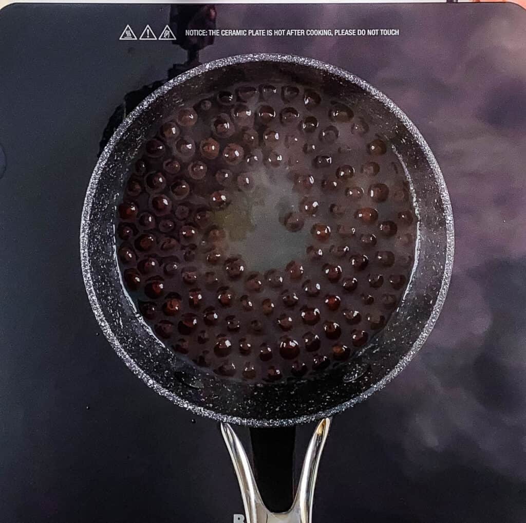 Boba pearls boiling in a pot.