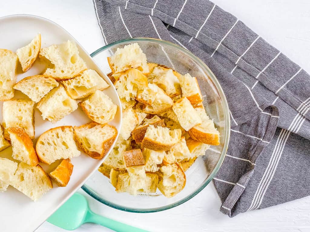 Bread for french toast being mixed with egg custard in a mixing bowl.