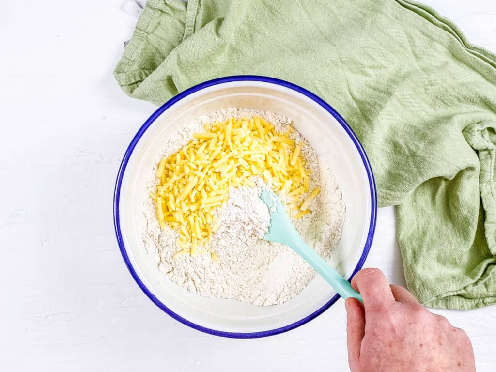 Dry ingredients for cheese rolls in a mixing bowl.