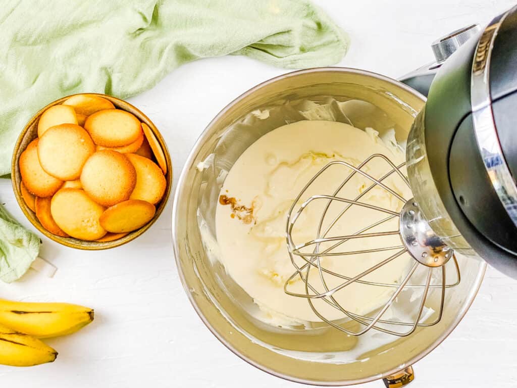 Cream cheese and sugar blended in a stand mixer.