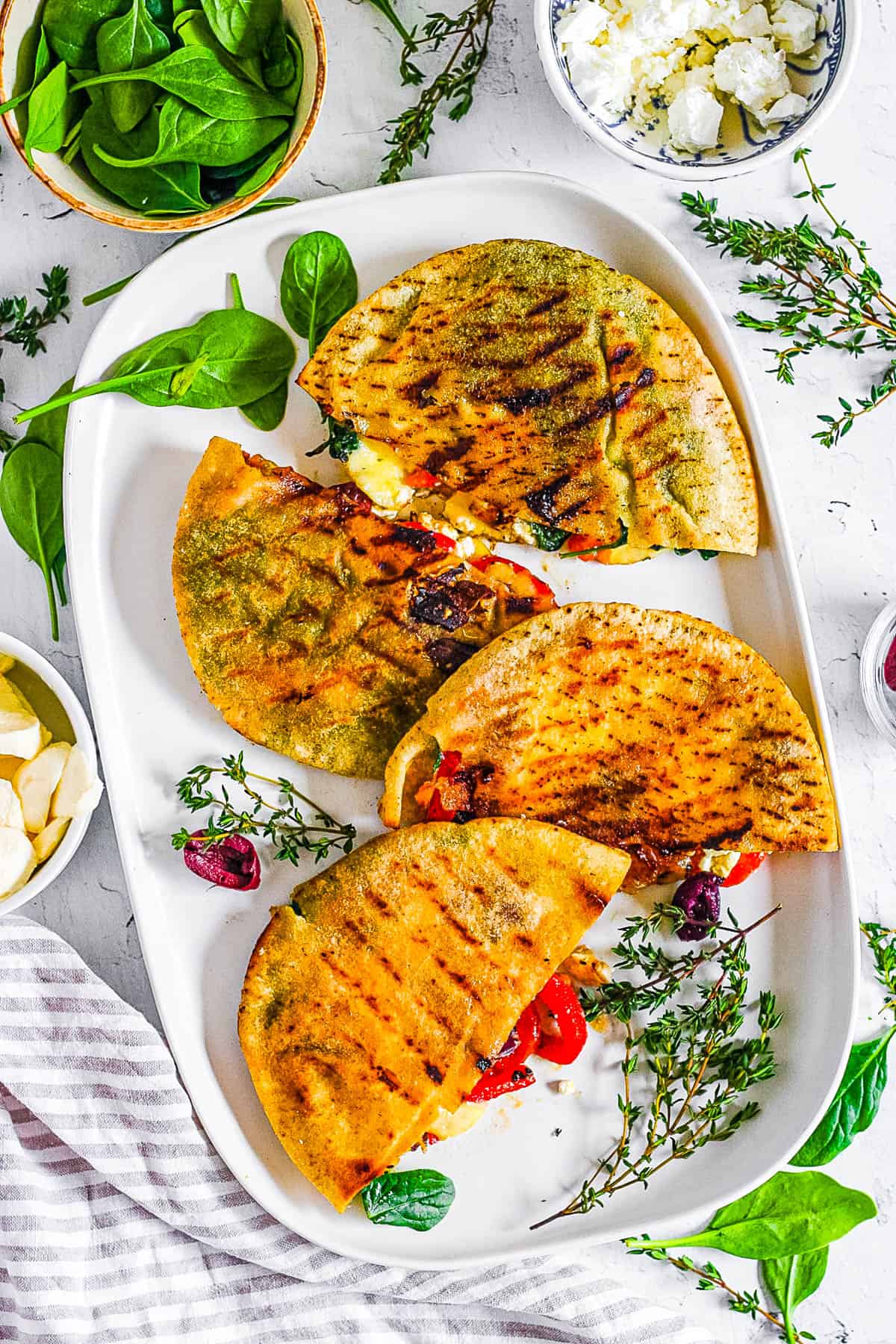 Grilled cheese pita sandwiches on a white platter