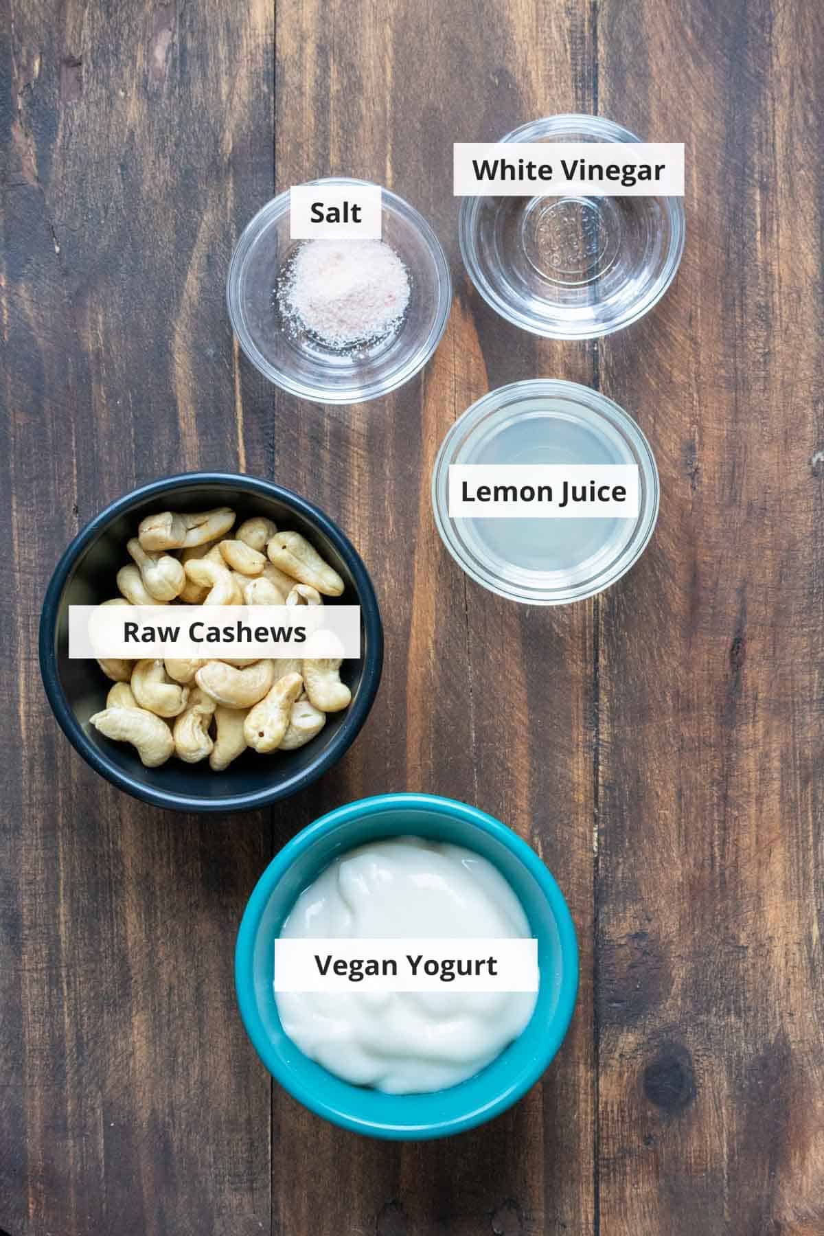 Ingredients for vegan cream cheese recipe on a wood background.