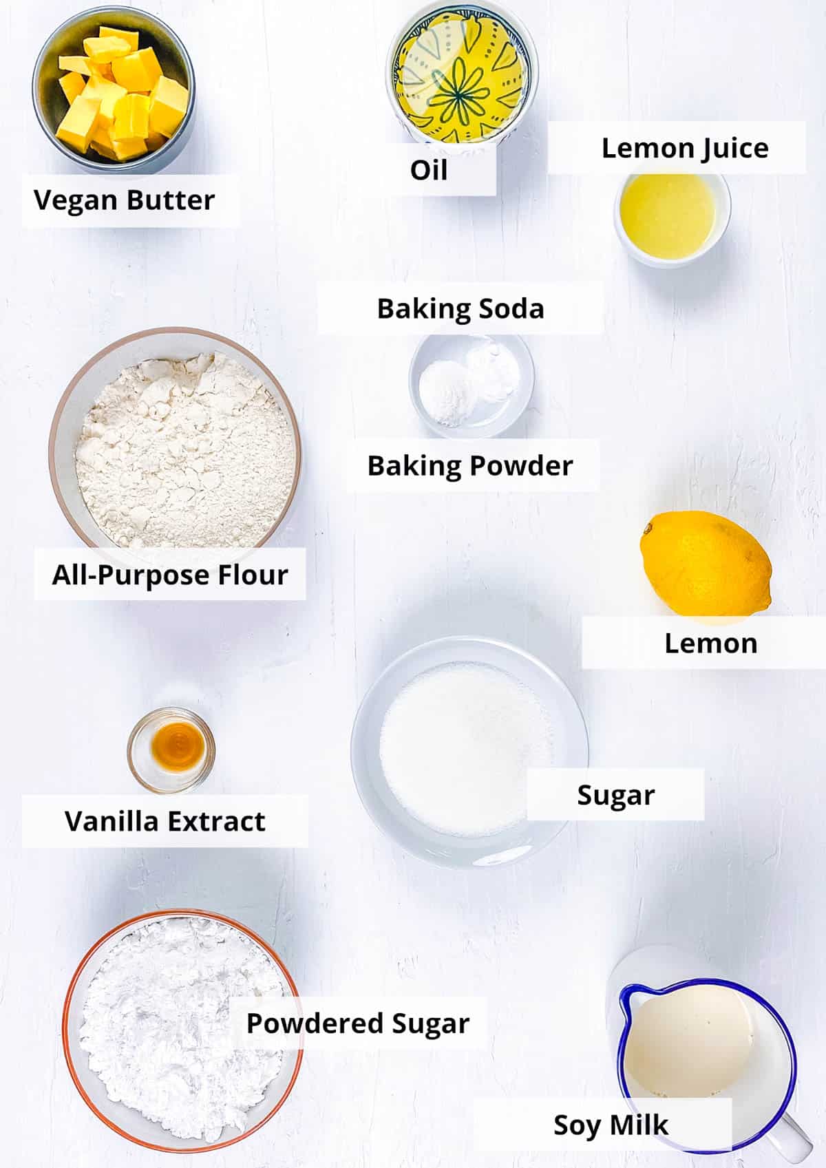 Ingredients for vegan lemon cupcakes recipe on a white background.